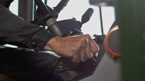 Tractor driver in the tractor cab engages gear on the gear selector Stock Footage 270060939