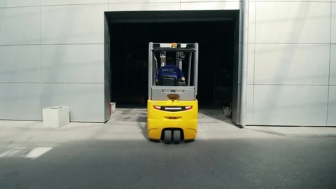 Tractor drives into a building Stock Footage 128170830