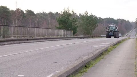 Tractor driving on a bridge in the netherlands Stock Footage 240732702