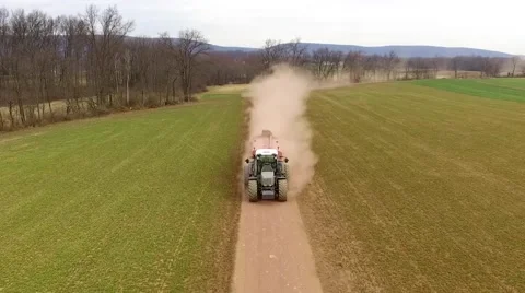 Tractor Driving Fast Down Dusty Dirt Field Lane Aerial Stock Footage 61175662