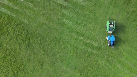 Tractor Driving In Field With Baler During Summer Top Down Stock Footage 214273560