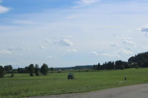Tractor driving in the field. Stock Photos