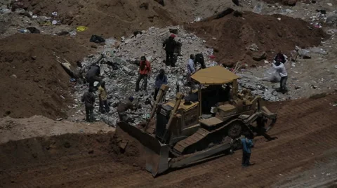 Tractor driving through dump in Guatemala Stock Footage 61158068