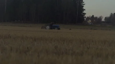 Tractor driving through explosions, tilted angle, slowmotion 動画素材 61405552