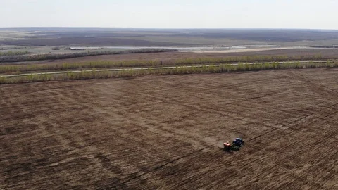 The tractor is driving through the field Stock Footage 89399505