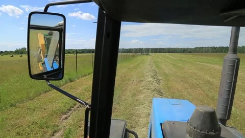THE TRACTOR IS DRIVING THROUGH THE FIELD Stock Footage 158127250