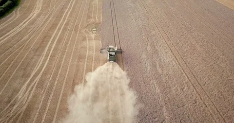 Tractor driving through field shot from above Stock Footage 89830936