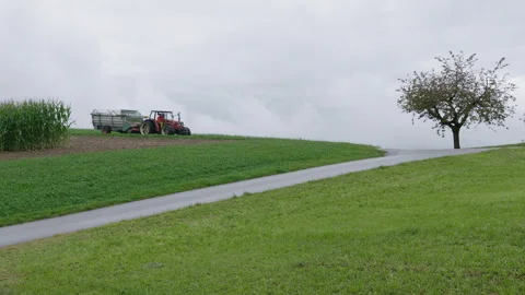 Tractor driving through hills Stock Footage 258419108