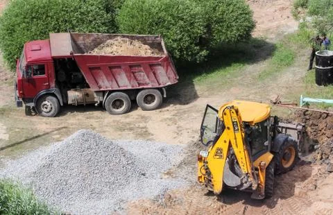 Tractor with dump truck on loading. Stock Photos