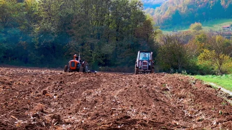 A tractor during work on the agricultural field. Video stock 227007213