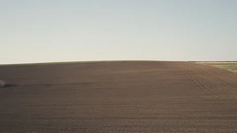 Tractor in the dust working in the field.  스톡 동영상 132087106