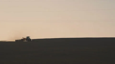 Tractor in the dust working in the field. Vidéo 132090950