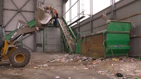 A tractor empties garbage into a container at a landfill Stock Footage 124707187