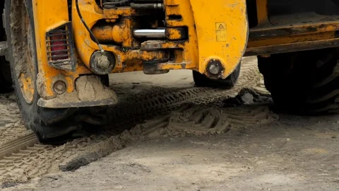 Tractor excavator rides in reverse during repair work at a construction site. Stock Footage 239374256