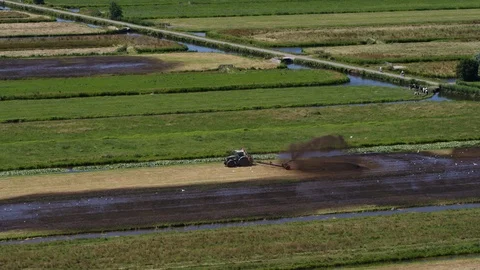 Tractor Farmer working Dutch field midday Video stock 103089413