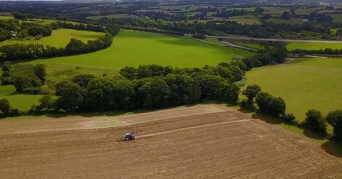 Tractor farming on field landscape Stock Footage 84880951