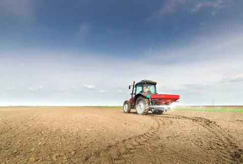 Tractor fertilizing in field Stock Photos