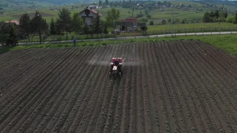 Tractor on field crop dusting Stock Footage 90400160