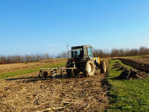 Tractor on the field at farm Stock Photos