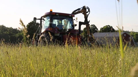 Tractor in field grass blowing Stock Footage 39639102