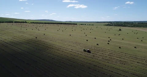 Tractor in field with haystacks Stock Footage 102285910