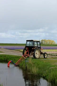 Tractor in a field with hose 스톡 사진