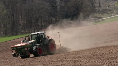 Tractor on the field with a lost of dust because of the dry field Stock-Footage 153161970