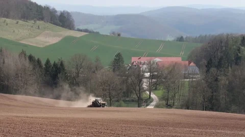 Tractor on the field with a lost of dust because of the dry field Stock Footage 153162121