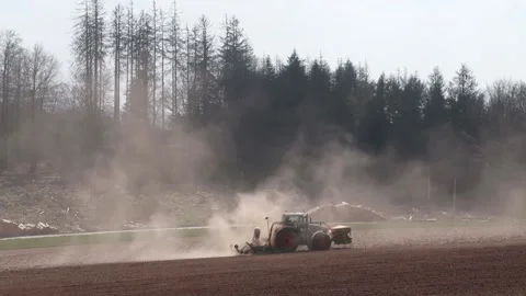 Tractor on the field with a lost of dust because of the dry field Stock-Footage 153162214