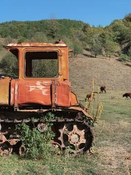 Tractor in the field in the mountains Stock Photos