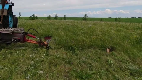 The tractor in the field to mow the grass, feed for animals Stock Footage 132719416