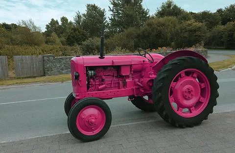 Tractor in the field in pink Stock Photos