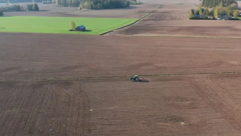 Tractor on the field plowing soil in spring Stock Footage 176373384