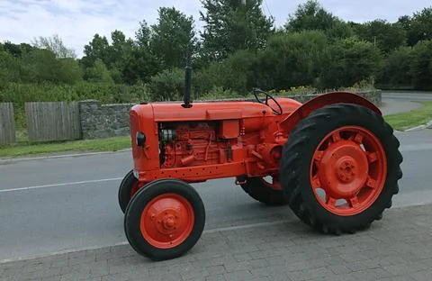 Tractor in the field in red. Stock Photos