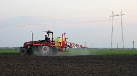 Tractor in field spraying ground after sowing Stock Footage 8835460