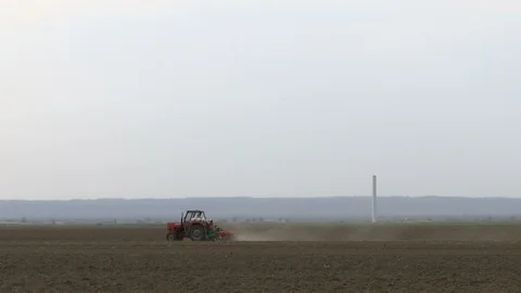 Tractor in the field on a strong wind Stock Footage 107376113