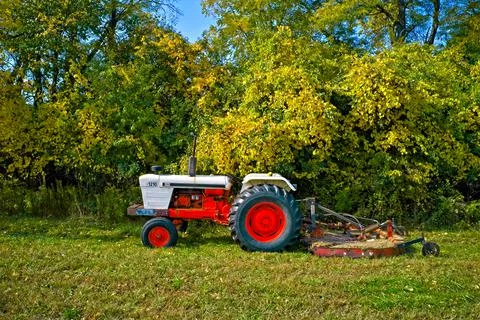 Tractor field trees side Stock Photos
