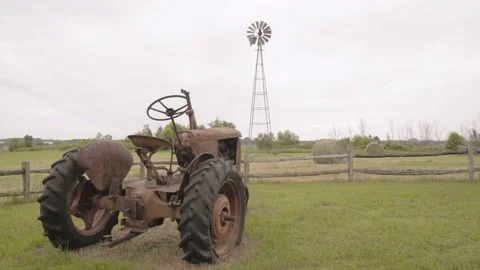 Tractor in Field Windmill Spinning Hay Bales Video stock 219225079