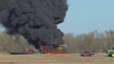 Tractor fire with explosions in field Stock Footage 143682597