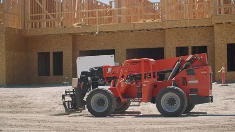 A tractor in front of a building Stock Footage 155539892