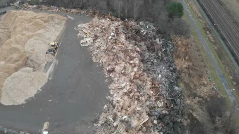 Tractor Front Loader Moving Sawdust at Wood Waste Landfill, Aerial Reveal Vídeos de archivo 148316665