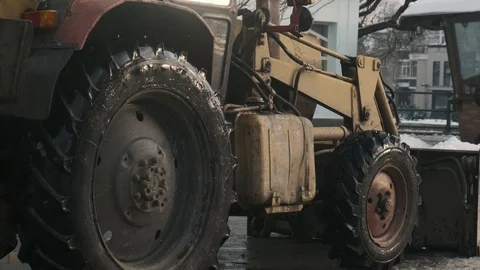 Tractor getting ready to work in the town square. Slow motion. 4k Видео 103284855