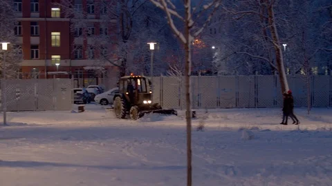 Tractor grader working in the snow covered park Stock Footage 123105943