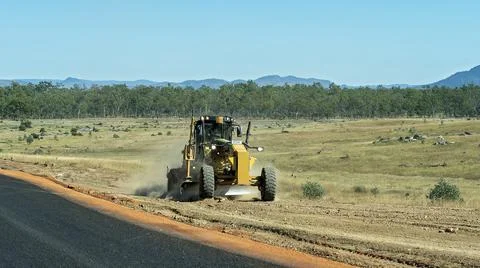 Tractor Grading The Roadside Stock Photos