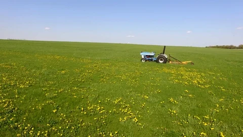 Tractor in a Grassy Field Stock Footage 91778338