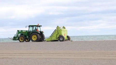 Tractor grooming a beach Stock Footage 242051653