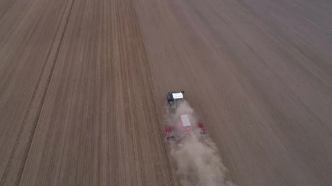 Tractor with harrow preparing large field, looping video Stock Footage 128525319