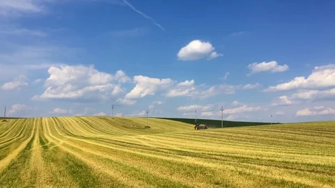 Tractor on the harvested empty field Stock Footage 75948652