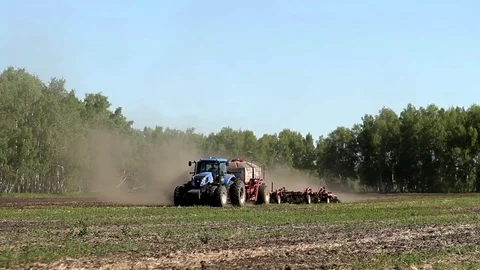 Tractor harvester on sowing. In late spring Stockbeeldmateriaal 74673171