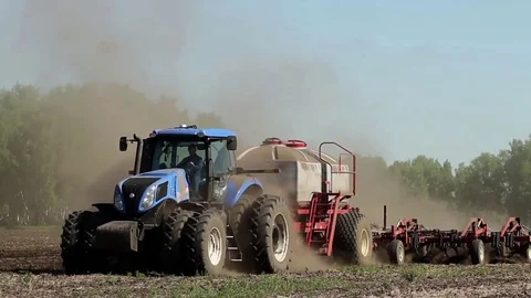 Tractor harvester on sowing. In late spring Stockbeeldmateriaal 74911357